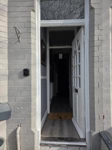 an open door of a house with a hallway at Ince House in Liverpool