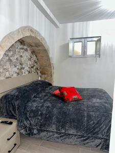 a bedroom with a bed and a stone wall at Residenza Ohana in Isernia