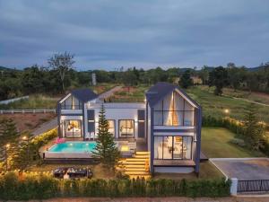 an aerial view of a house with a swimming pool at I-DIN POOL VILLA khaoyai in Ban Nong Song Hong