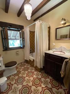 a bathroom with a sink and a toilet and a shower at Posada Rural Valoria in Valoria