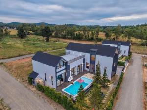 an aerial view of a house with a swimming pool at I-DIN POOL VILLA khaoyai in Ban Nong Song Hong +7 photos