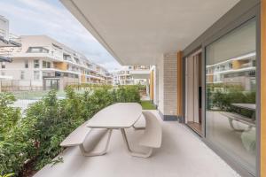 a white bench on the balcony of a building at The Captainhouse in Nieuwpoort