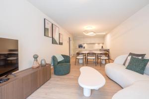 a living room with a couch and a table at The Captainhouse in Nieuwpoort