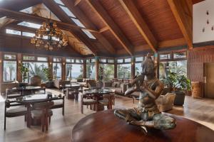 a living room with a statue sitting on a table at Orchid Eilat Hotel in Eilat