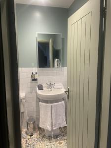 a white bathroom with a sink and a mirror at The Bear Tattenhall in Tattenhall +11 photos