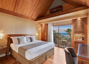 a bedroom with a bed and a balcony at Orchid Eilat Hotel in Eilat +70 photos