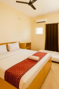 a bedroom with two beds and a window at Mysore Couple Friendly at 999 in Mysore