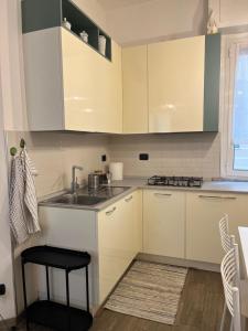 a kitchen with white cabinets and a sink at Casa Angiolina in Chiavari