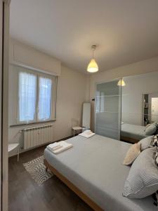 a bedroom with a large bed and a bathroom at Casa Angiolina in Chiavari +10 photos