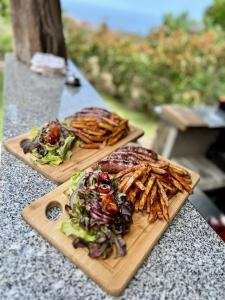 two wooden cutting boards with food on a table at Casa Sant'Antone in Santa-Reparata-di-Balagna