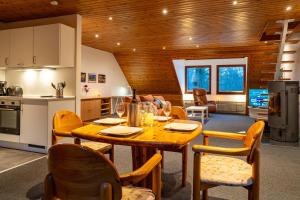 a kitchen and dining room with a wooden table and chairs at FeWo-Tannenriede in Braunschweig