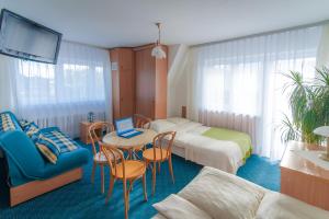 a hotel room with two beds and a table with a laptop at Nasz Dom in Kościelisko