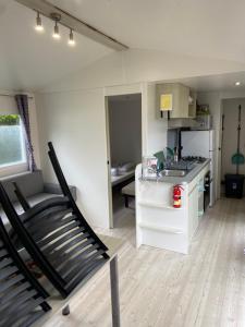 a kitchen and living room with a treadmill in a room at l'impasse de la tranquillité in Pont-Aven