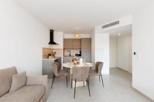 a living room and kitchen with a table and chairs at Féeries Provençales YourHostHelper in Grimaud