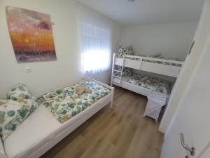 a small room with two beds in it at Urlaub am Weinhof Ramminger in Gleisdorf