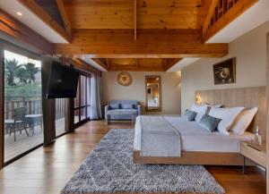 a bedroom with a large bed and a balcony at Herbert Samuel Royal Shangri-La Eilat in Eilat