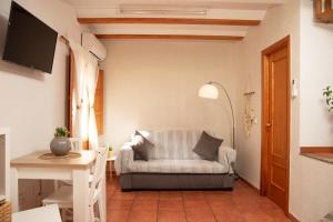 a living room with a couch and a table at Castle House Xativa in Xàtiva