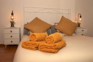a bedroom with a bed with towels on it at Castle House Xativa in Xàtiva