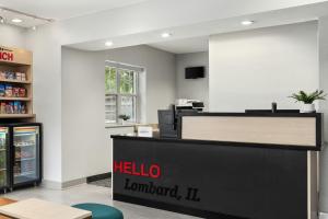a melico store with a reception desk and a sign at TownePlace Suites Chicago Lombard in Lombard