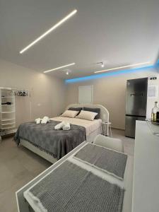 a bedroom with a bed and a blue light at Blue Breeze in Paralia Vrachou