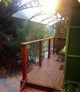 a wooden deck with a sunvisor on a house at Dees Front Studio Room in Hazelbrook