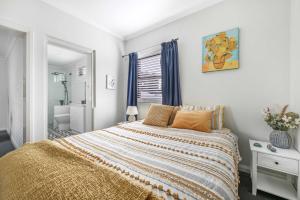 a bedroom with a large bed and a bathroom at Coorabin in Orange +28 photos