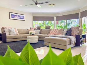 a living room with a couch and a table at Solis Acreage Escape in Advancetown