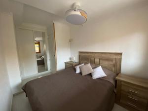 a bedroom with a bed with two pillows on it at Apartament La Mata in La Mata +4 photos