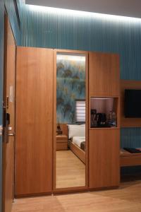 a room with a bedroom with a bed and a sliding door at Kratos Lifestyle in Surat
