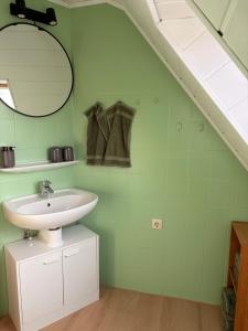 a bathroom with a sink and a mirror at Ferienwohnung Weitblick in Großheide