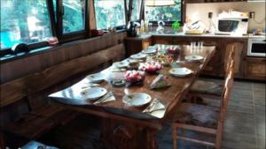 a long wooden table in a kitchen with a table sidx sidx sidx at Мома Елена in Makhalnitsi