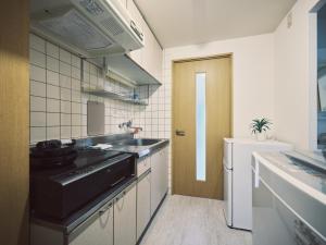 a small kitchen with a sink and a stove at vetta kumamoto suizenji2 308 in Kumamoto