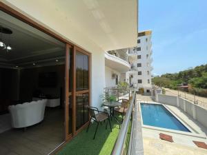a balcony with a pool and a table and chairs at Aqua kingstone apartments in Mombasa