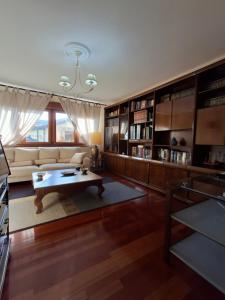 a living room with a couch and a table at As Pitas 1 in Tapia de Casariego