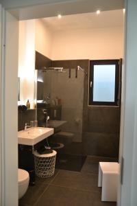 a bathroom with a sink and a toilet and a shower at Bergweide 36 in Sasbachwalden +20 photos