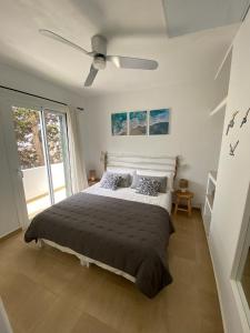 a bedroom with a bed and a ceiling fan at M&B Blue Beach in Son Xoriguer +15 photos