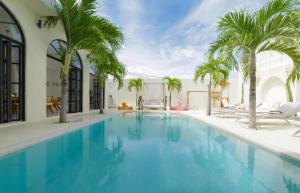 a swimming pool with palm trees in a house at 5BR Ocen View Villa in Jimbaran in Jimbaran
