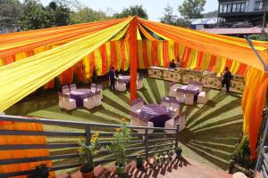 an overhead view of a tent with tables and chairs at Hotel RP Residency in Nakraunda