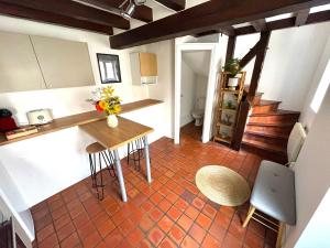 an overhead view of a kitchen with a table and chairs at Le Duplex du Pont in Auxerre +12 photos