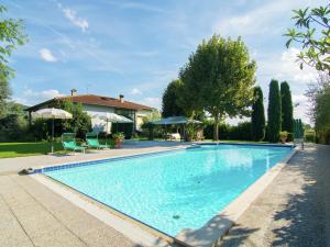 コルトーナにあるModern Holiday Home in Cortona with Poolのスイミングプール(椅子2脚付)と家