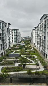 a row of apartment buildings with a courtyard with trees at The Everly Lhesson Kuching in Kuching