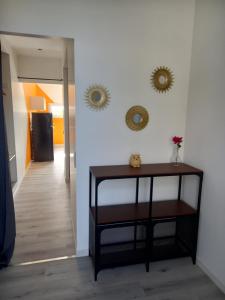 a room with a table and two mirrors on the wall at Chez Sophie, au calme, climatisé, proche d'Aix-les-bains in Grésy-sur-Aix