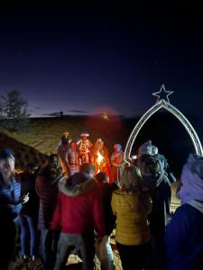 a group of people standing in front of a star display at Isma Luxury Camp in Merzouga