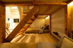 a loft bed with two beds in a room at SUNZ ROOMS -naha miebashi- in Naha