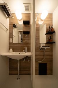 a bathroom with a sink and a shower at SUNZ ROOMS -naha miebashi- in Naha