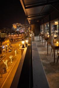 a restaurant with a view of a city at night at Whitestone Hotel in Nevşehir