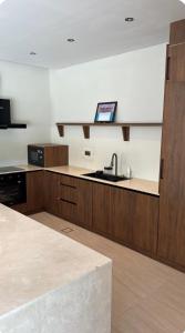 a kitchen with a sink and a counter top at Malath Farm in Al Rahba