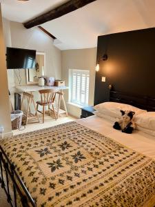 a bedroom with a bed with a teddy bear sitting on it at The Ivy House in Chalfont Saint Giles