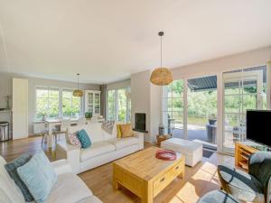 a living room with a couch and a table at Scandinavisch Nr. 221 | 8 Pers. Jacuzzi in Zeewolde