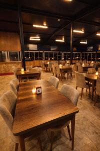 a dining room with a wooden table and chairs at Whitestone Hotel in Nevşehir +21 photos